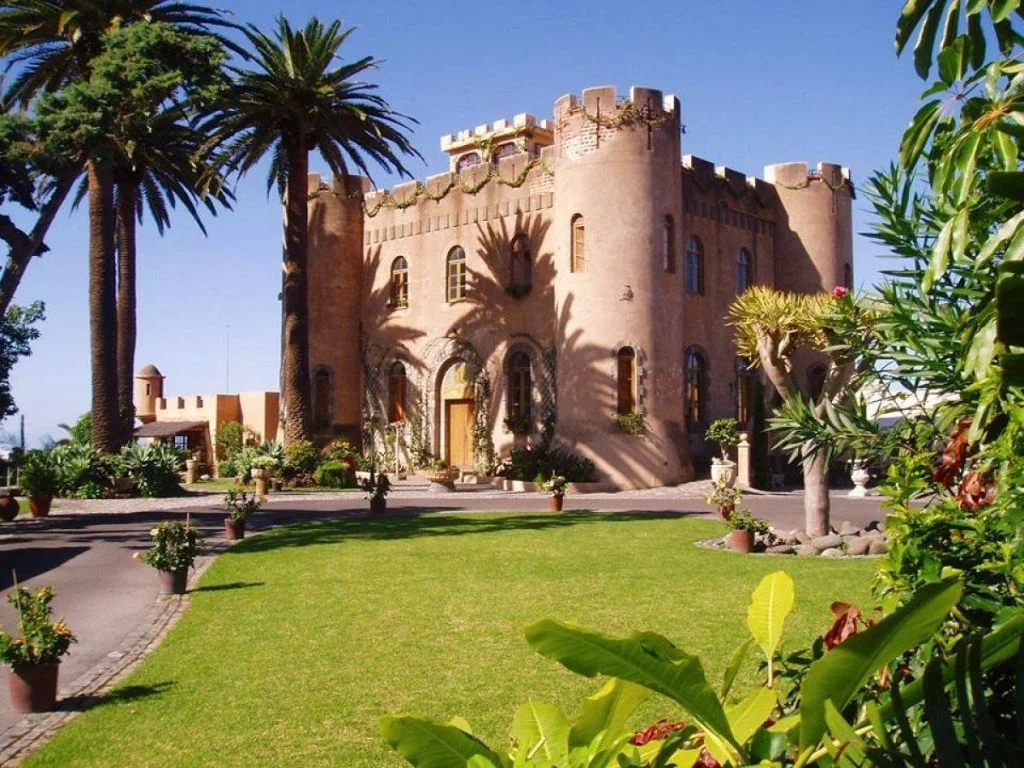 Castle-style wedding venue surrounded by palm trees and tropical gardens in the Canary Islands