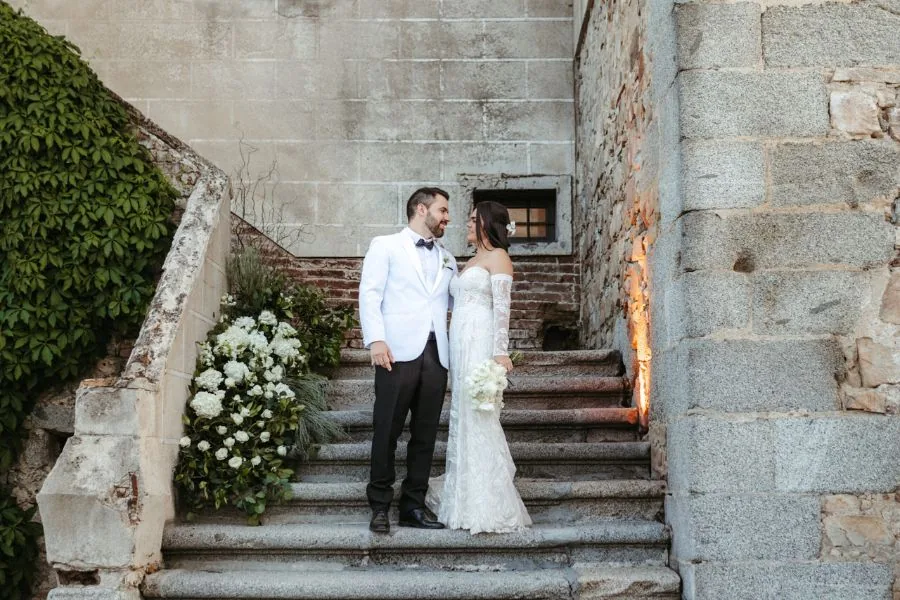 Bride and groom on grand stone steps, a Lisbon wedding in Portugal planned by Swish Soirées