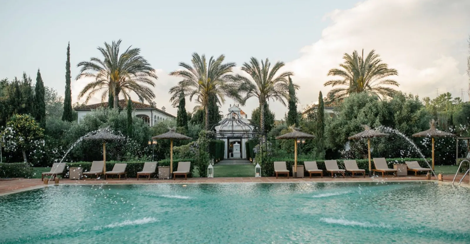 The pool and palm gardens of a wedding venue in the Cádiz countryside, near Sotogrande
