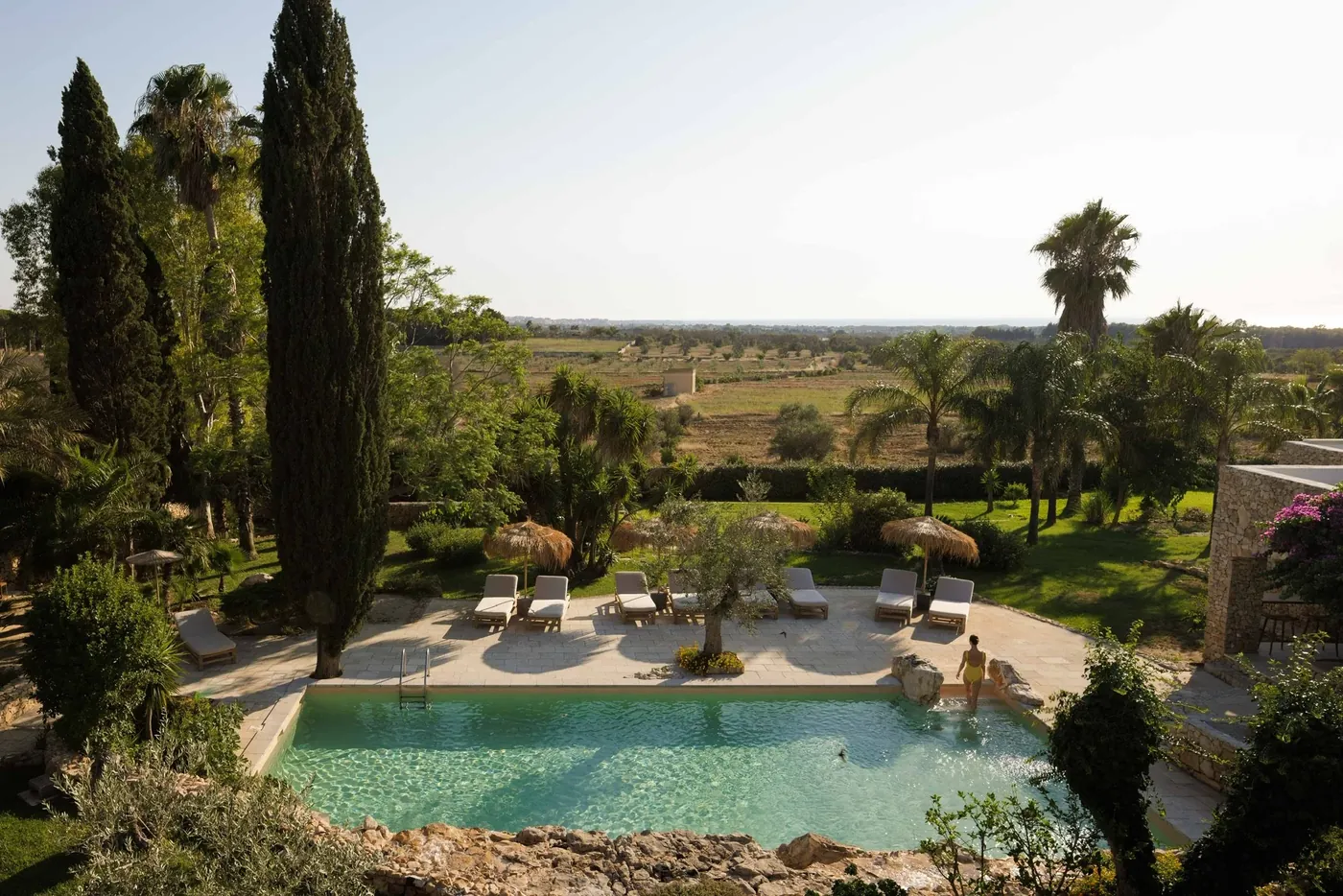 Pool and gardens at golden hour, Tenuta Negroamaro wedding venue, Salento, Puglia